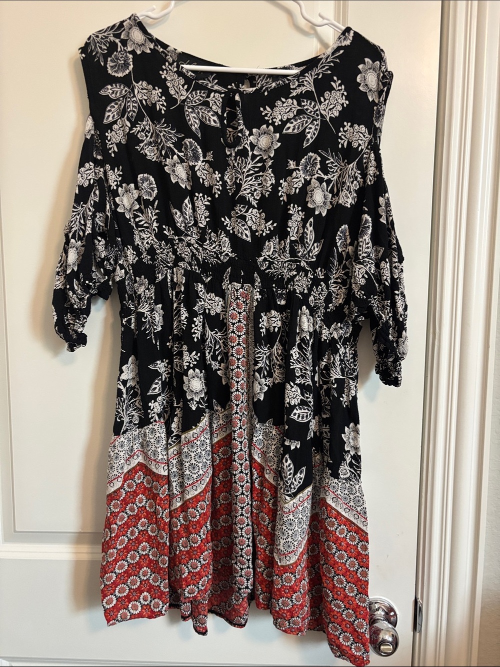 Lola P. Black Floral Tiered Romper with Red Geo Border. Open shoulder Sleeves.